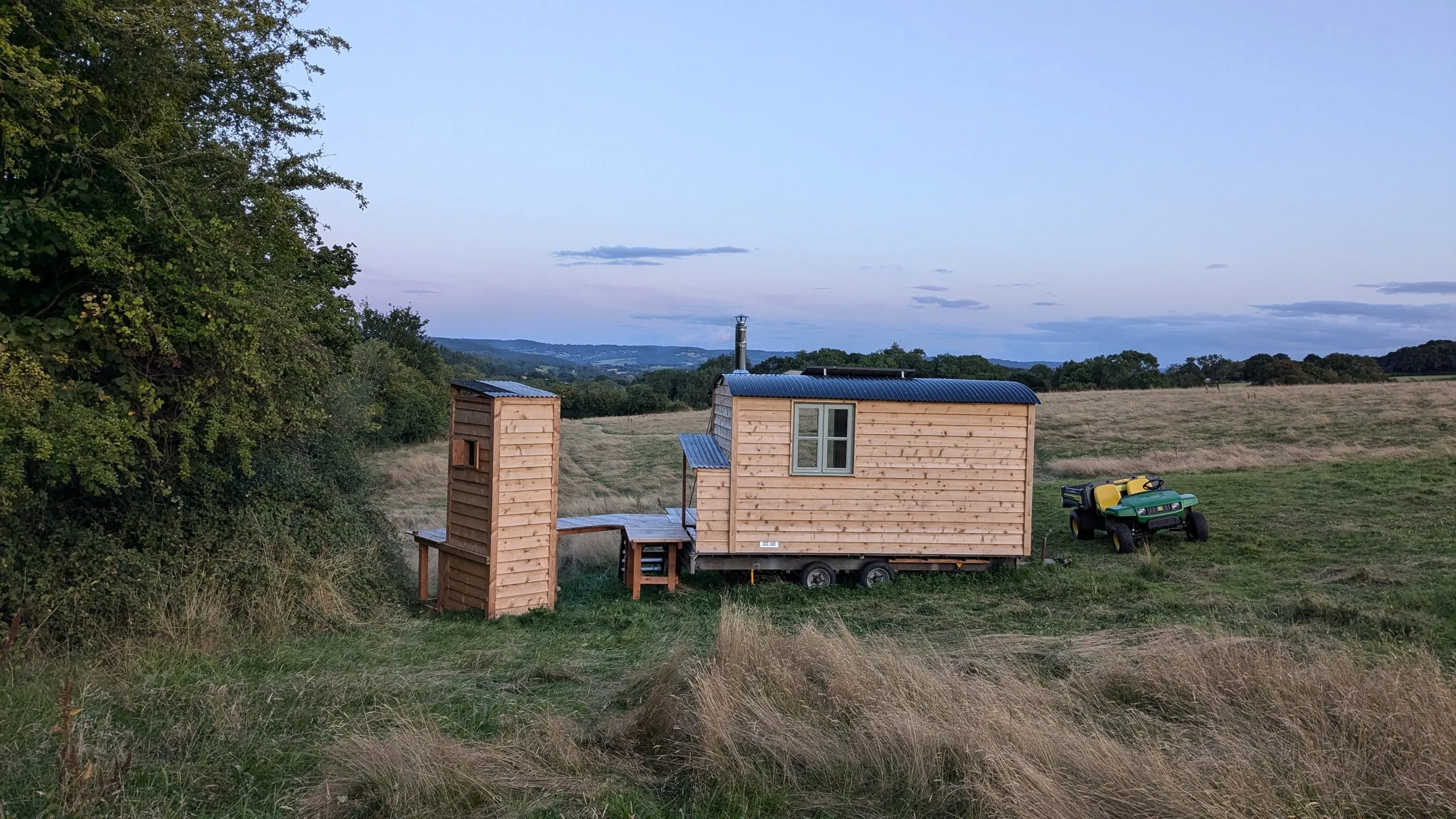 Evening glow over off-grid escape cabin in Monmouthshire