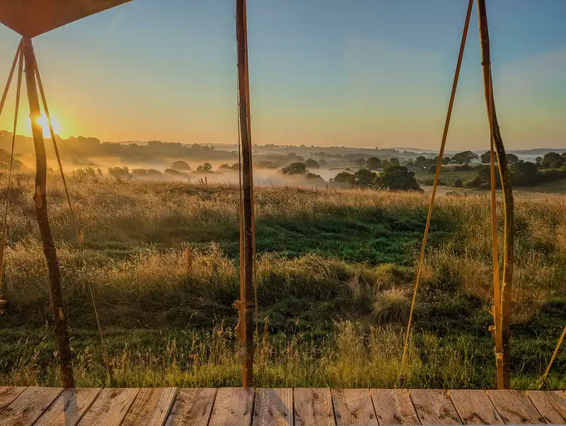 Bell tent glamping in wildflower meadow at The Grange Project
